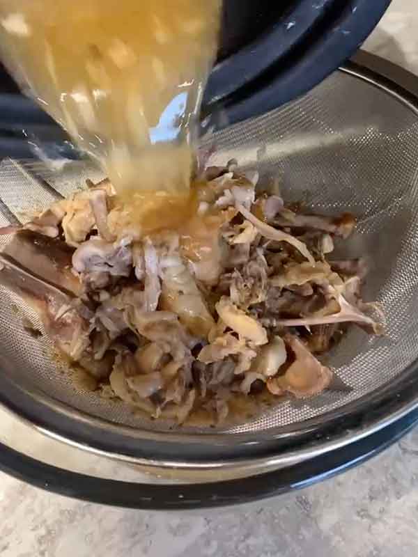 straining the chicken bone broth