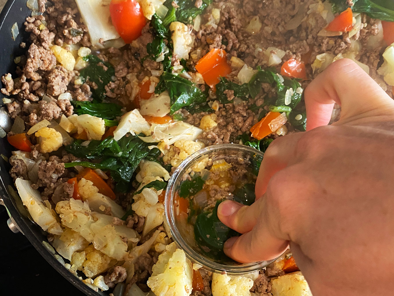 Adding wells to breakfast scramble using a small bowl
