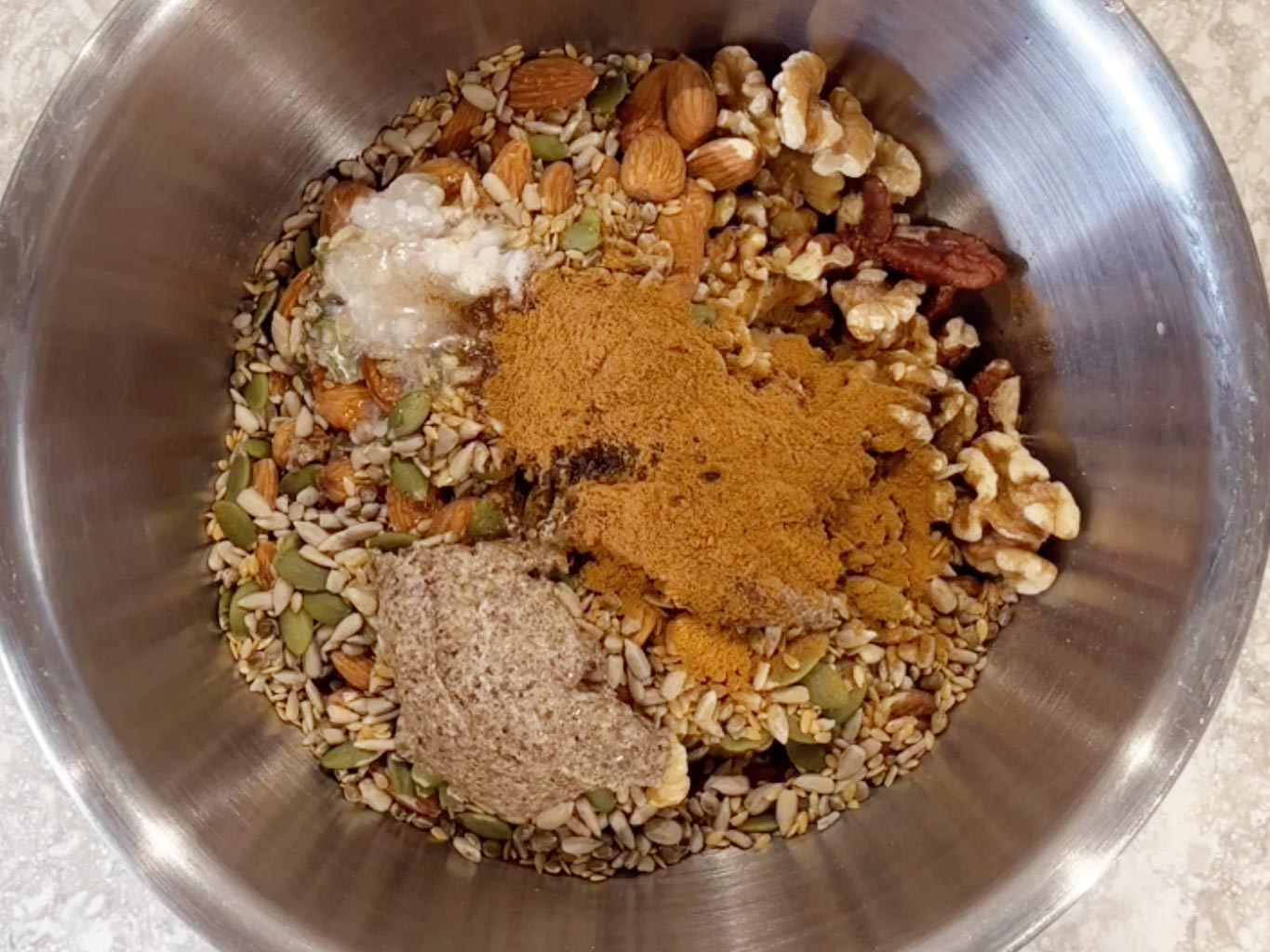 Add flaxseed paste, cinnamon, melted coconut oil, vanilla powder and granulated xylitol to the bowl